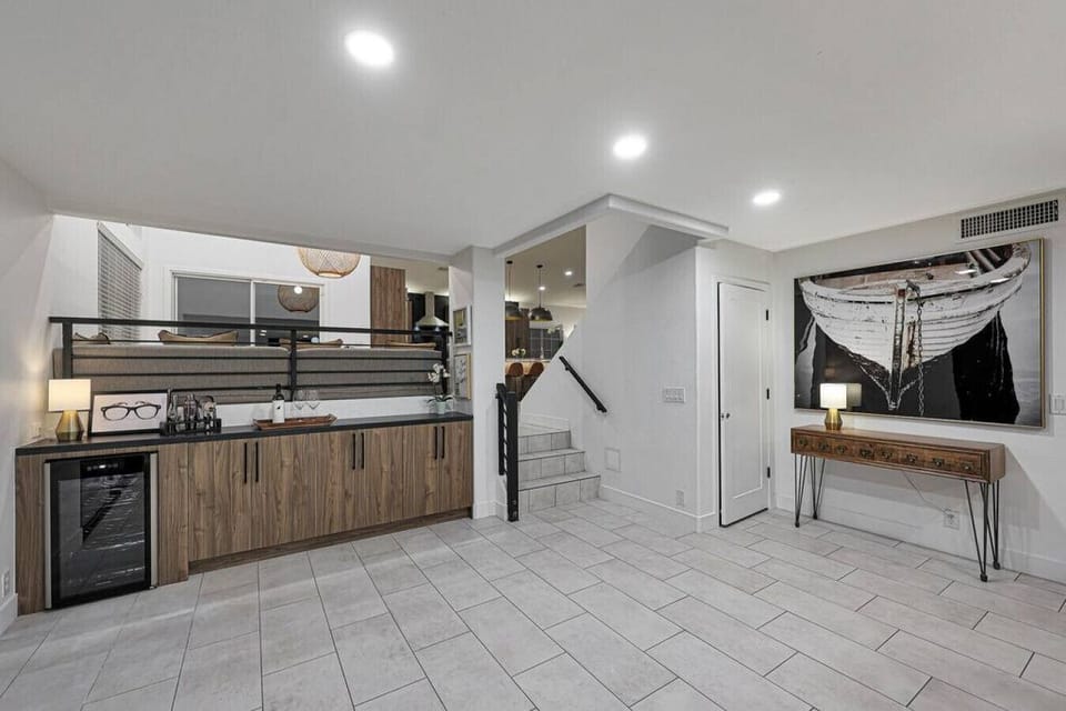 Host with ease at the dedicated wet bar, complete with a wine cooler and stylish cabinetry, located just steps from the kitchen.