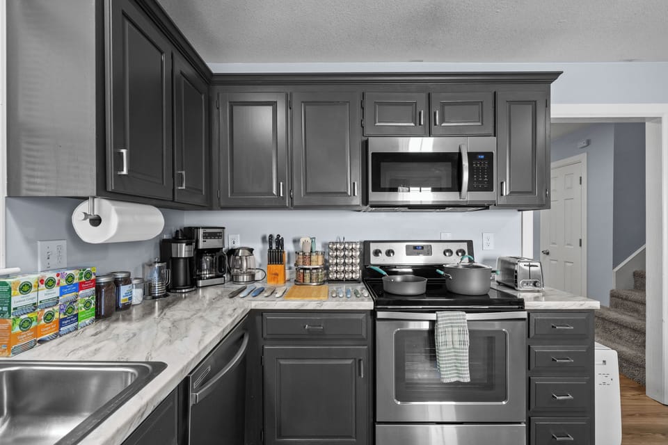 Kitchen with coffee station, kettle, teas, spices, and all cooking essentials.