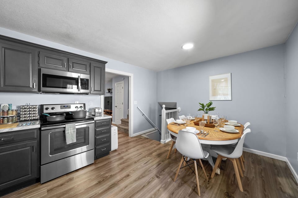 Cozy dining space with stylish table near kitchen, perfect for meals or takeout.