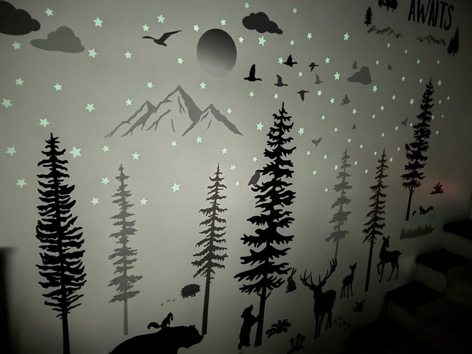 Glow in the dark art in 1st floor kids room.  Room has kids seating with TV.