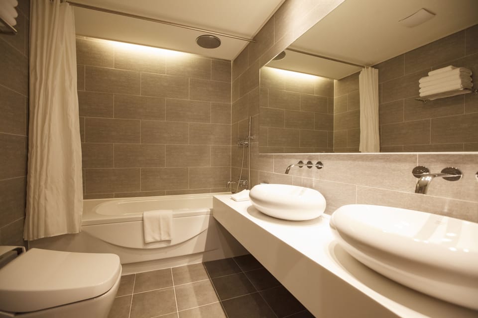 Quadruple Room | Bathroom | Deep soaking tub, rainfall showerhead, hair dryer, bathrobes