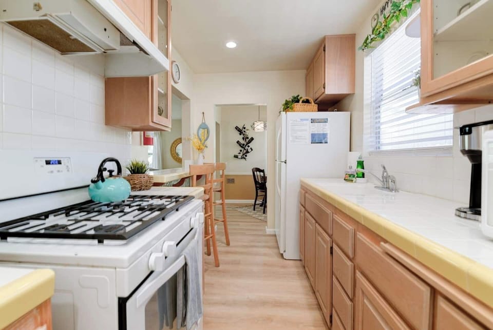Kitchen - Cozy breakfast bar, gas stove, refrigerator, fully stocked with dishes and pots & pans.