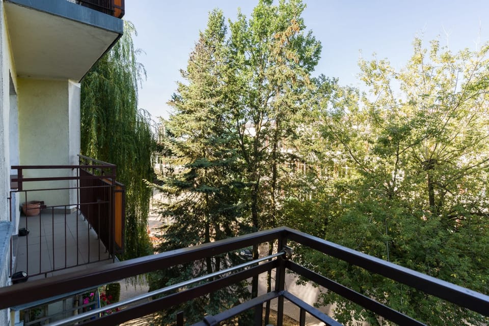 Another angle of the balcony, overlooking lush trees and creating a serene and private retreat.
