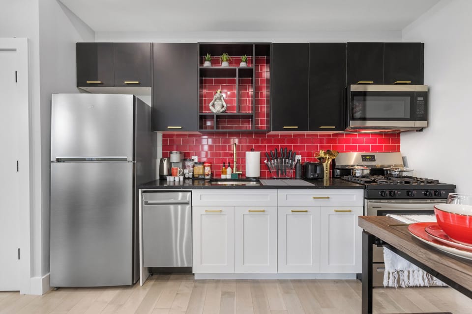 Fully-equipped kitchen with modern stainless steel appliances, ample countertop space, and a wide range of cookware, ensuring a seamless cooking experience for all your culinary needs.
