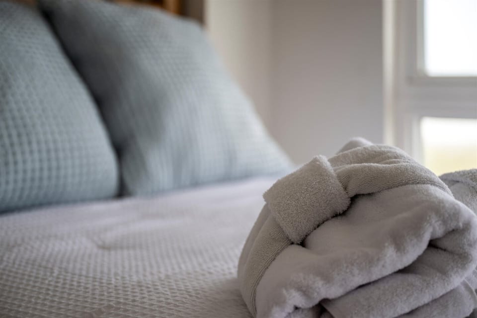 Fresh linens and soft textures create a relaxing retreat for a restful night’s sleep.