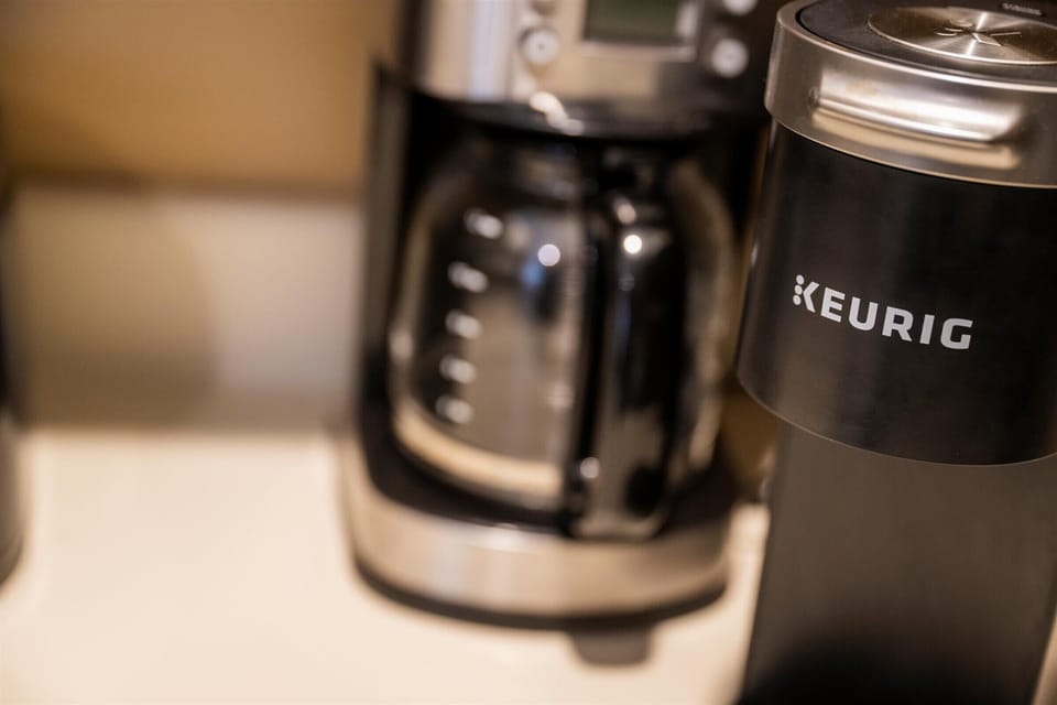 Start your mornings right with a convenient coffee station, featuring both a Keurig and a traditional drip coffee maker.