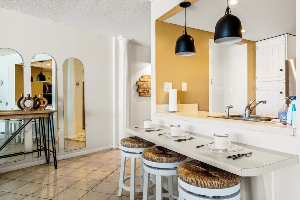 A clean, open kitchen with modern lighting and all the essentials you need to feel at home during your stay.