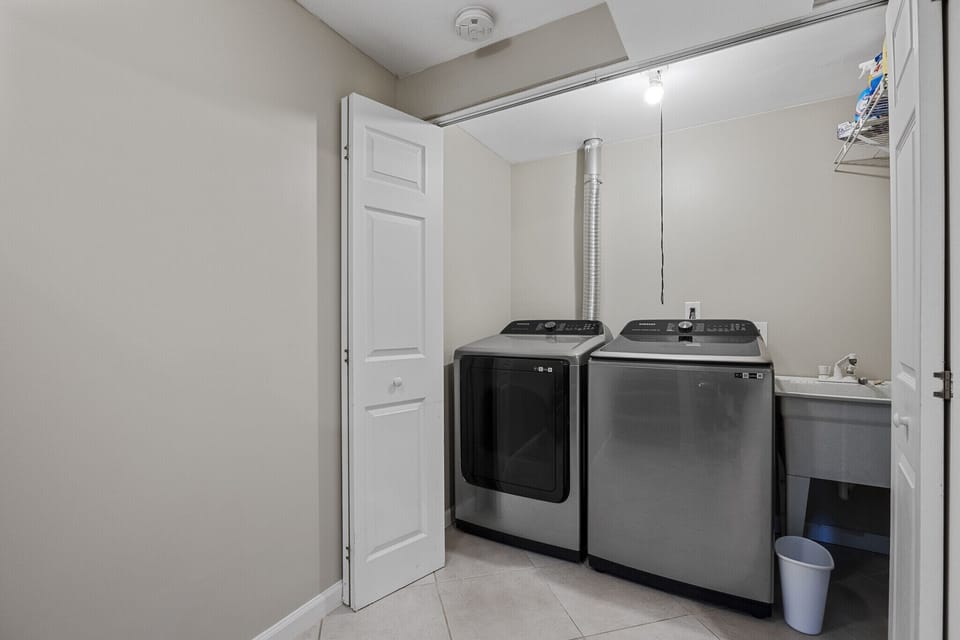 Basement laundry room with laundry pods, dryer sheets and stain remover spray