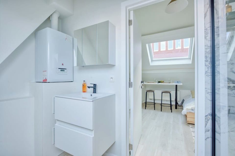 Superior hardwood flooring connecting the bedroom to the bathroom and kitchen.