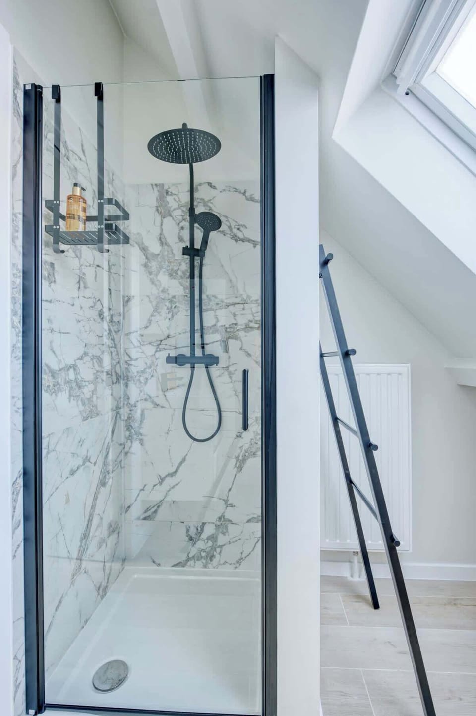 Step inside this walk-in shower, with beautiful ornate porcelain tile added on the walls for extra luxury.