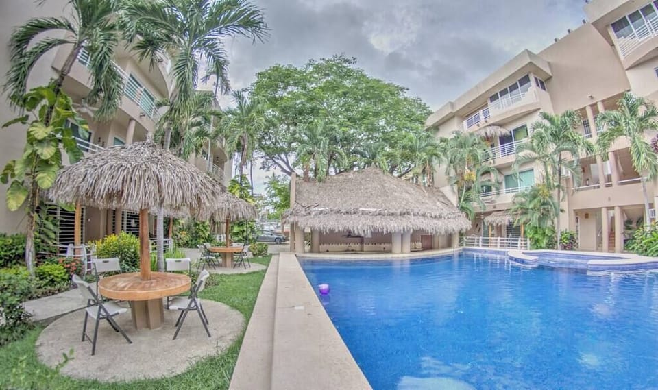 Large pool area with lounge chairs and seating areas.