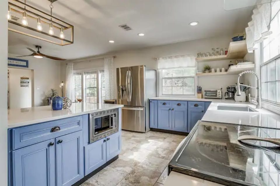 Kitchen is fully stocked with cooking supplies and utensils. 