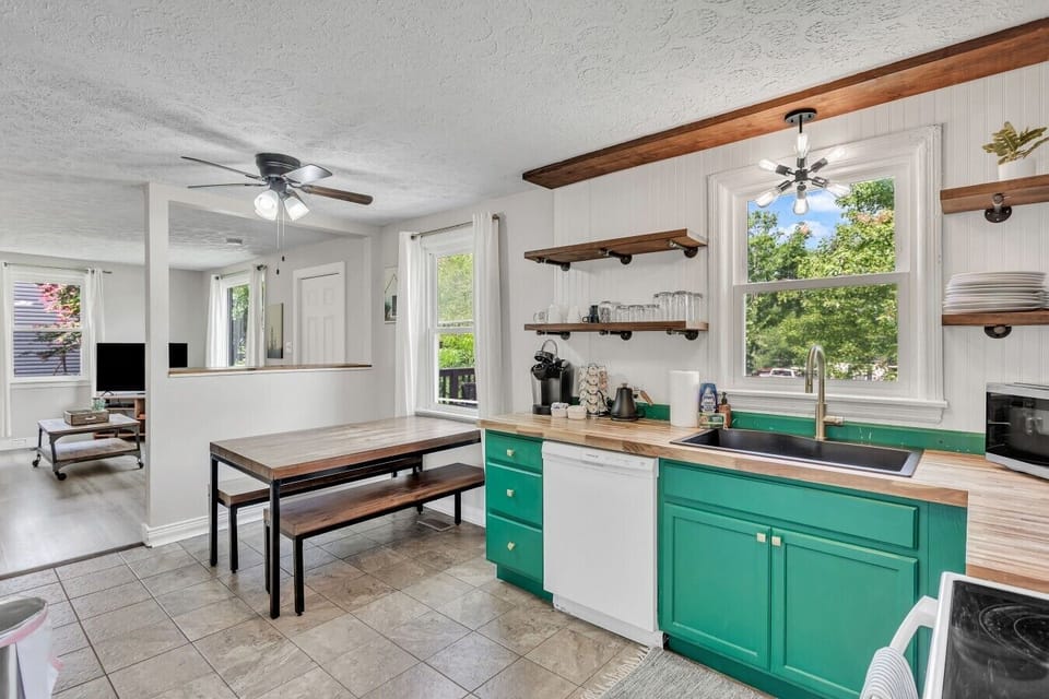 Kitchen, dining room and living room spaces.