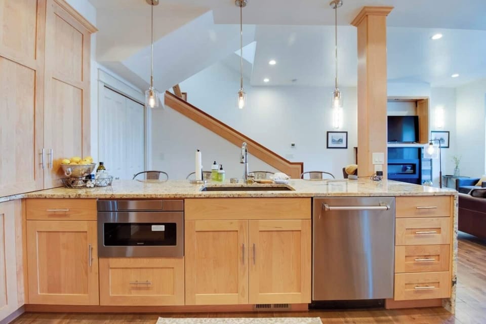 Open Chef's Kitchen with microwave drawer, dishwasher, and seating for 4 at island.