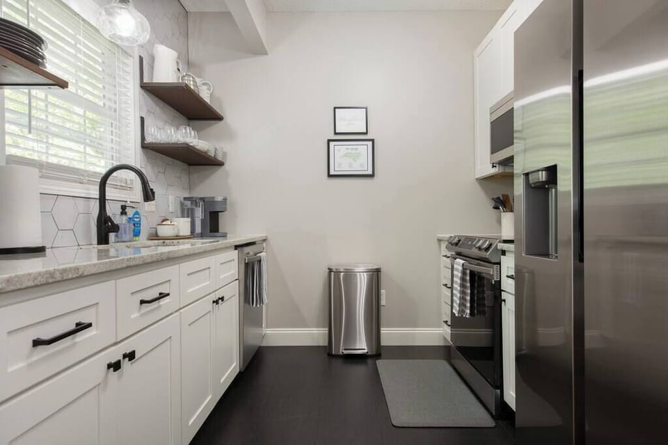 Stainless steel appliances and open concept shelving make dinner prep and clean up so easy!
