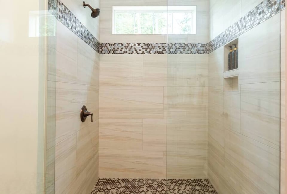 A spacious walk-in shower with great natural light