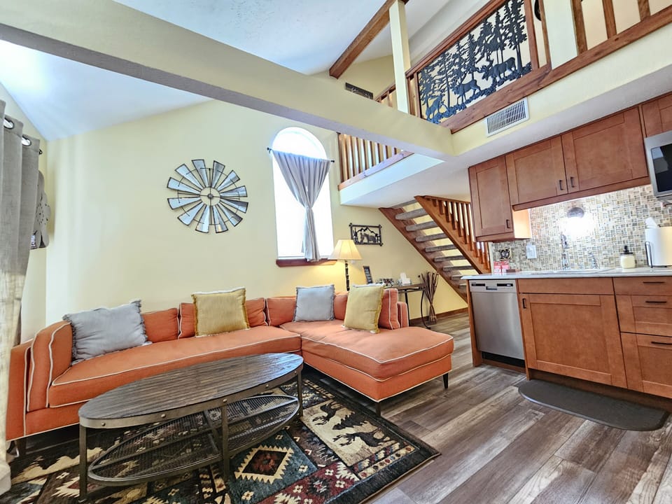 Living room and huge, comfortable sectional, cabin decor, & rustic coffee table!
