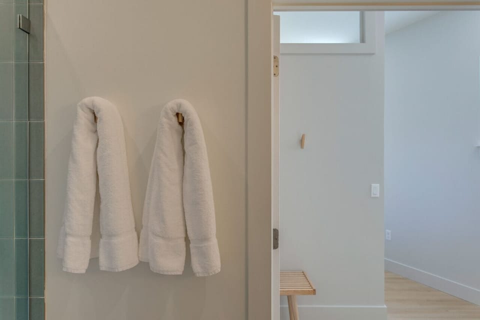 Renovated full size bathroom with two sinks.