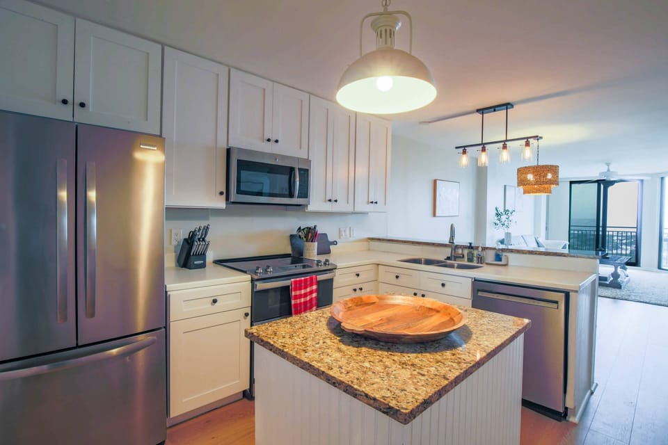 There is plenty of room to prepare your meals in this clean, white kitchen.