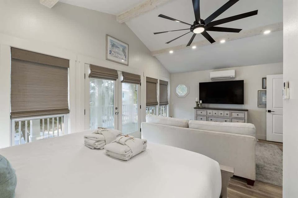 - Large windows with shades fill the suite with natural light throughout the day - French doors lead to the balcony, perfect for morning coffee or evening breezes - Serene coastal artwork & soothing hues enhance the atmosphere for restful nights