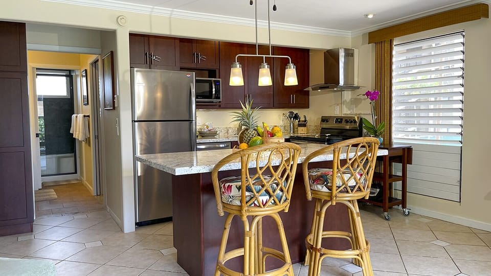 Full size stainless steel appliances and Keurig coffee maker.