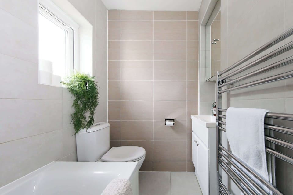 A family bathroom has towels and toiletries for all guests.