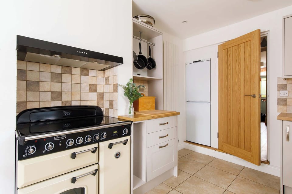 An adjacent kitchen has everything you need for your stay.