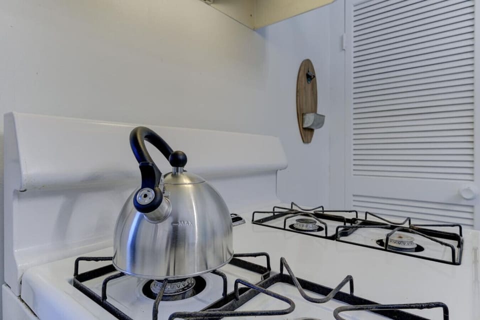 Teapot on the stove—your cue for a warm, quiet moment.