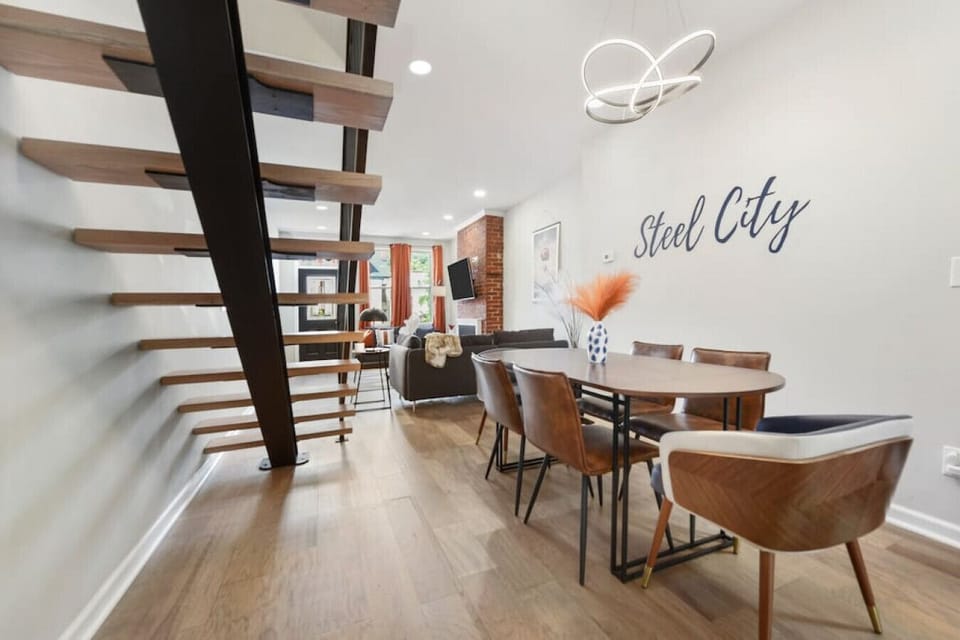 Architectural staircase leading to bright, open living spaces