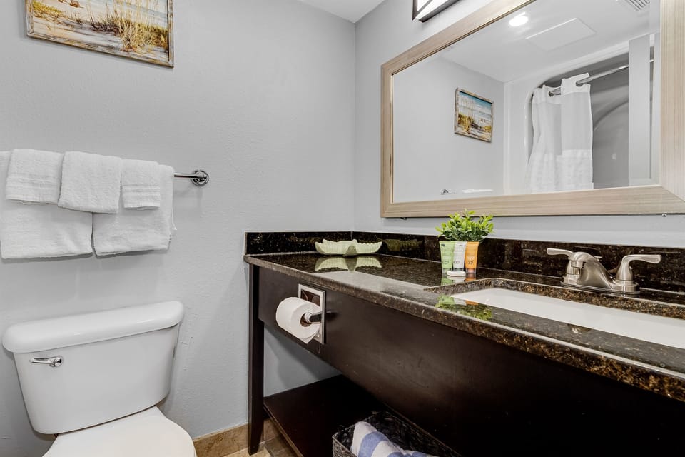 Escape to tranquility in our full bathroom, a sanctuary of relaxation nestled within our coastal studio. 