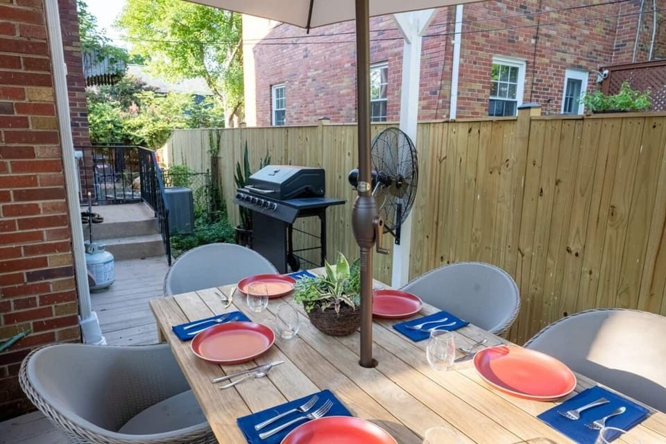 Private backyard area with teak dining table and comfortable chairs.  There is an umbrella and a fan to beat the heat on those hot summer days.  Propane gas barbecue grill available for cooking out.