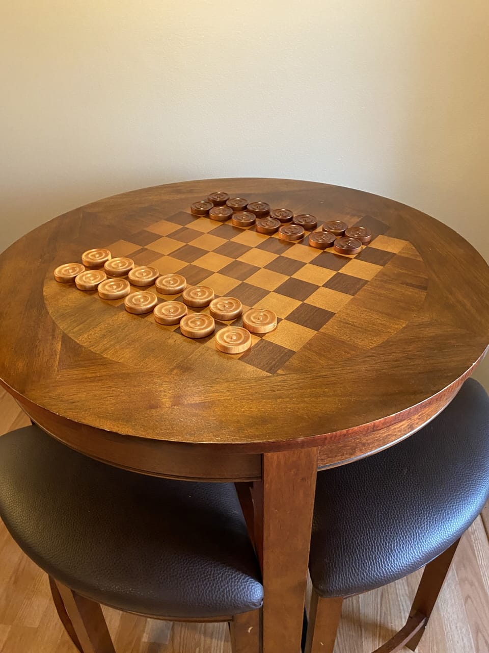 Game table with seating for 4. Checkers, games, and playing cards are provided.