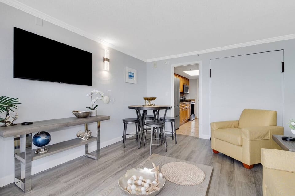 The living room offers versatile sleeping options with a convertible sofa bed, a Murphy bed, and an additional floor mattress for your convenience.