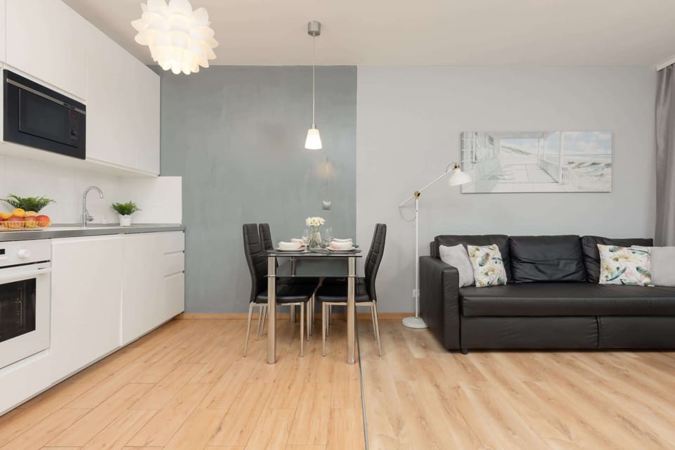Another angle of the open-plan living room and kitchen, with a sleek design.
