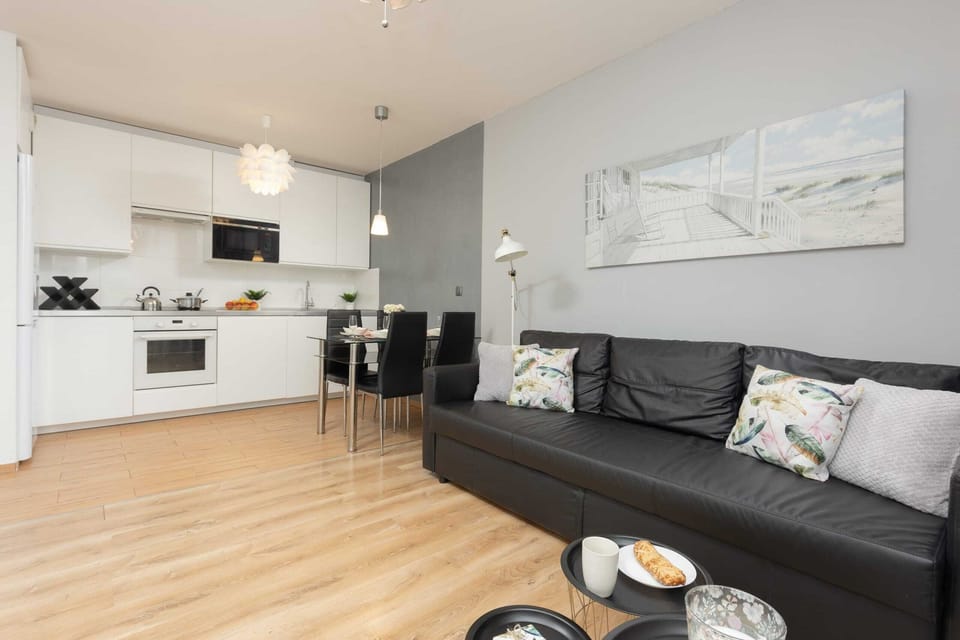 Another angle of the open-plan living room and kitchen, with a sleek design.
