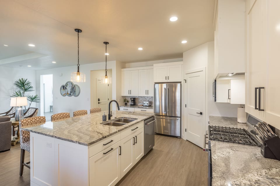 View of Kitchen - The Kitchen is complete with everything you will need for meal preparations including pots, pans, baking dishes, plates, cups, silverware, cutlery, and an assortment of cooking utensils.