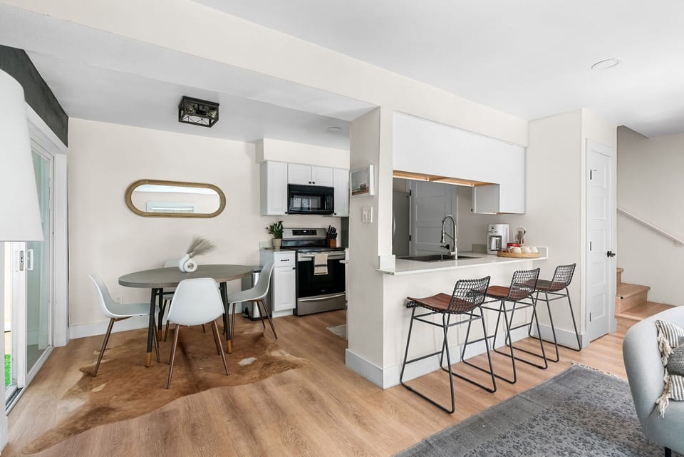 Gather 'round! Family meals just got even better with these stunning hardwood floors and ceiling in the kitchen.