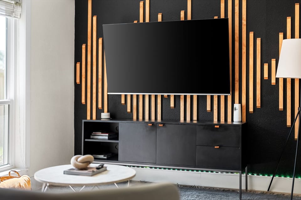 The TV complements the rest of my room decor, adding a modern touch to the space.