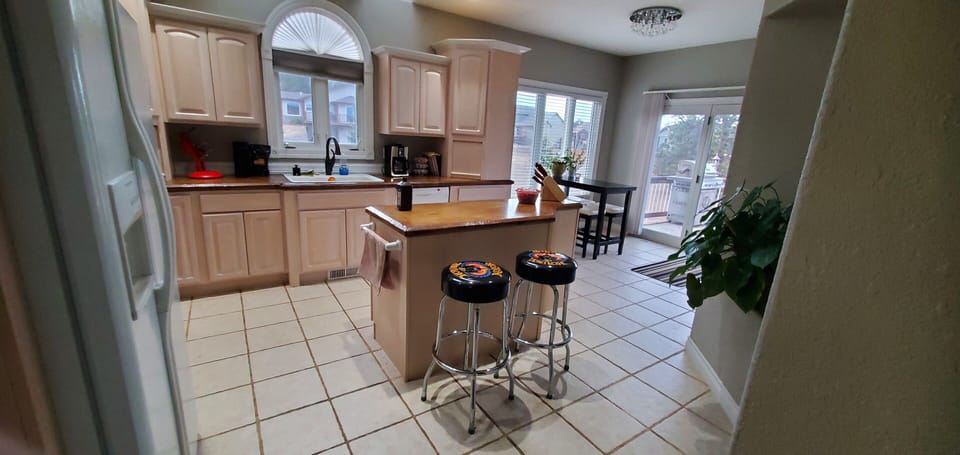 Kitchen-stovetop, indoor, coffee and or coffee maker, kitchen, kitchen visible, daytime, kitchen island with seating