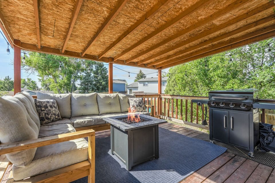 Just outside the kitchen, you'll find a cozy seating area with a propane fire pit for grilling and relaxing. As the sun sets, enjoy the string lights for ambiance or catch a show on the Smart TV mounted on the deck. Perfect for unwinding!