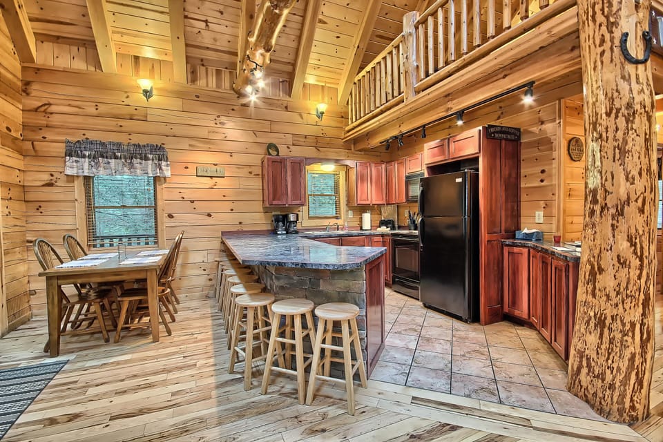 View of Dining Table and Full Kitchen, with Bar and Barstools