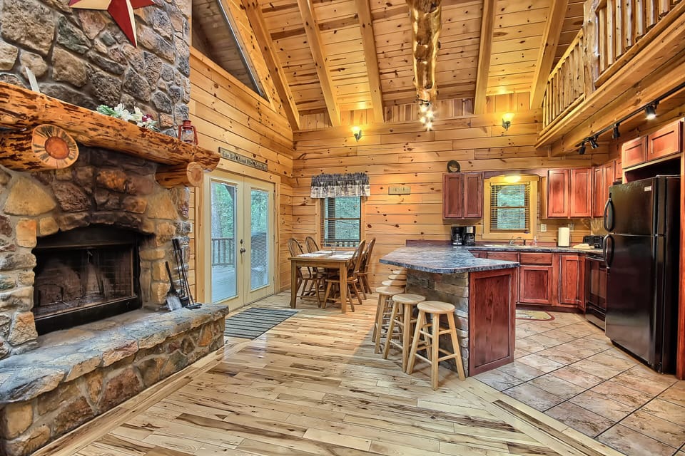 Closeup of Fireplace, with Dining Area, Breakfast Bar, and Kitchen beyond