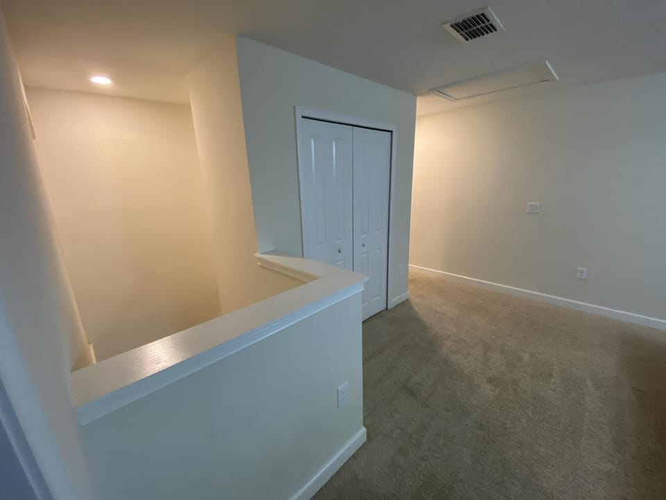 Bright upstairs landing with access to bedrooms and storage.