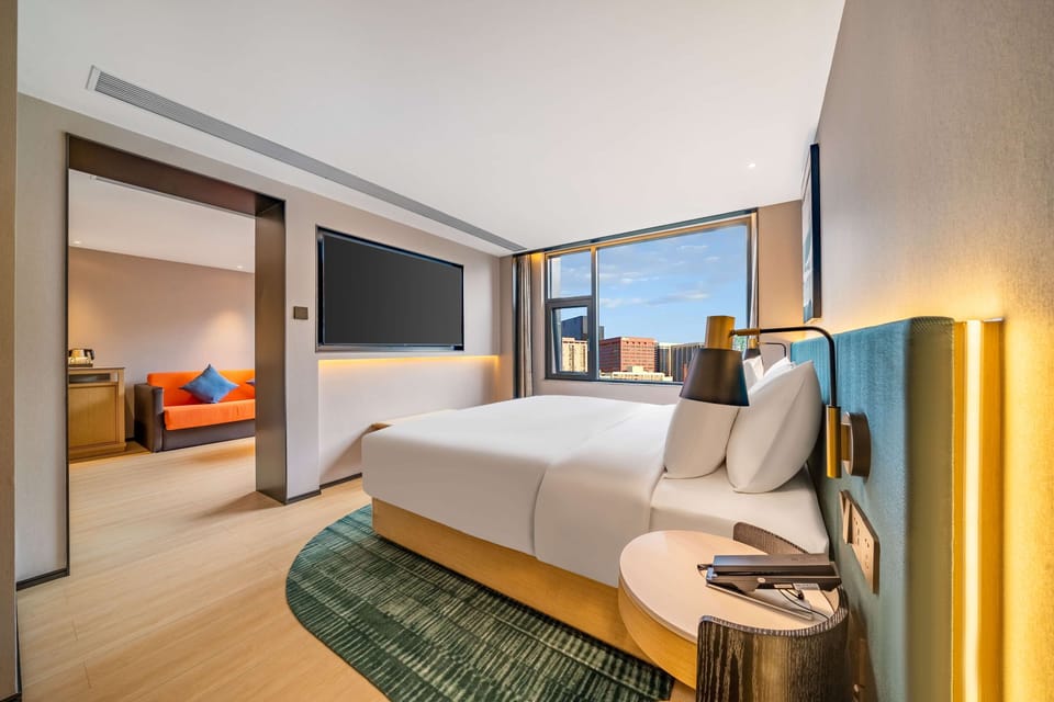 Suite, 1 Bedroom | Living area | 69-inch TV with cable channels
