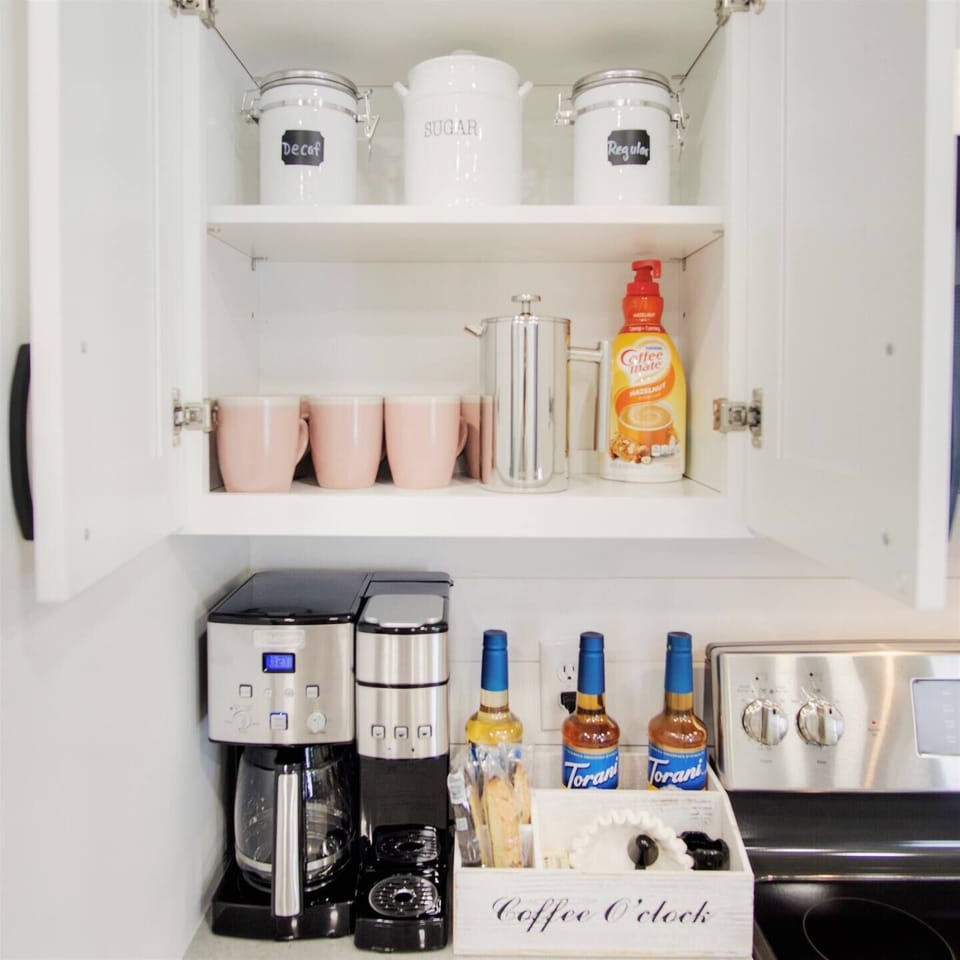 Coffee bar stocked with all of your coffee needs! Various coffee types, syrups, French Press, k cups, drip coffee, etc!