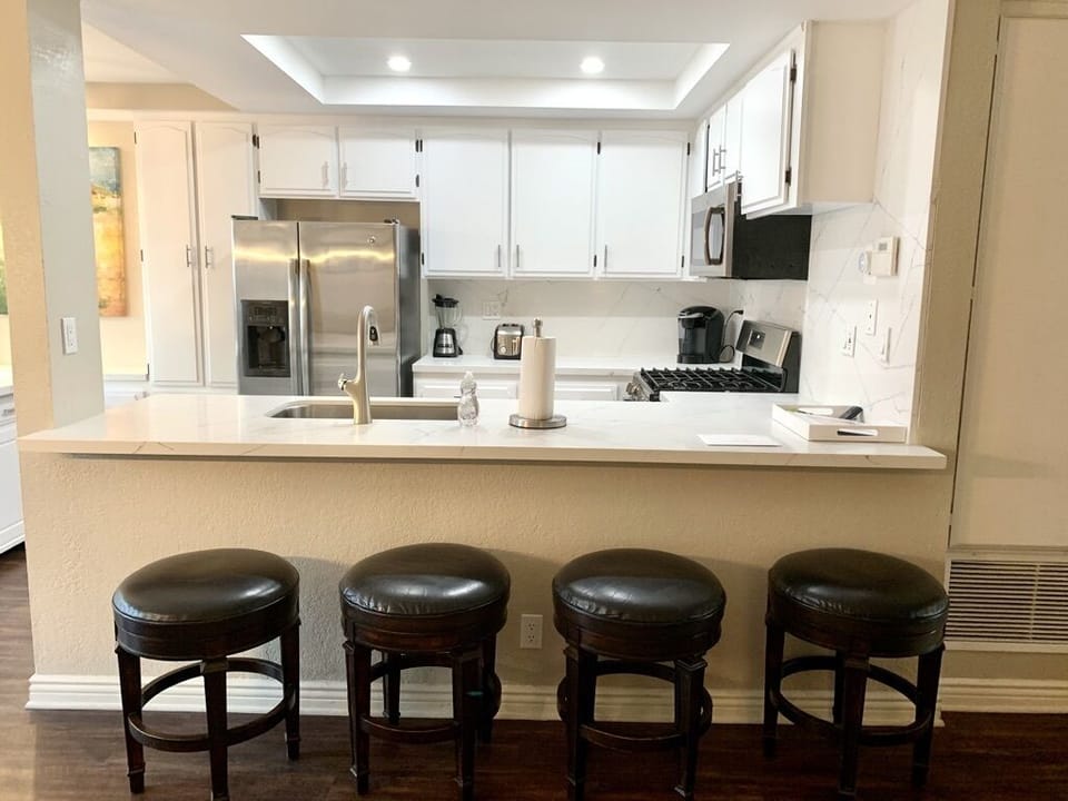 New stove, sink, faucet and Keurig coffee maker with 4 leather swivel barstools