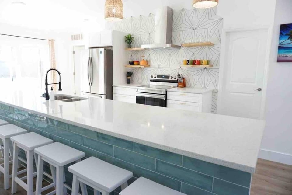 The open kitchen design features an island and plenty of room to prepare meals. 
