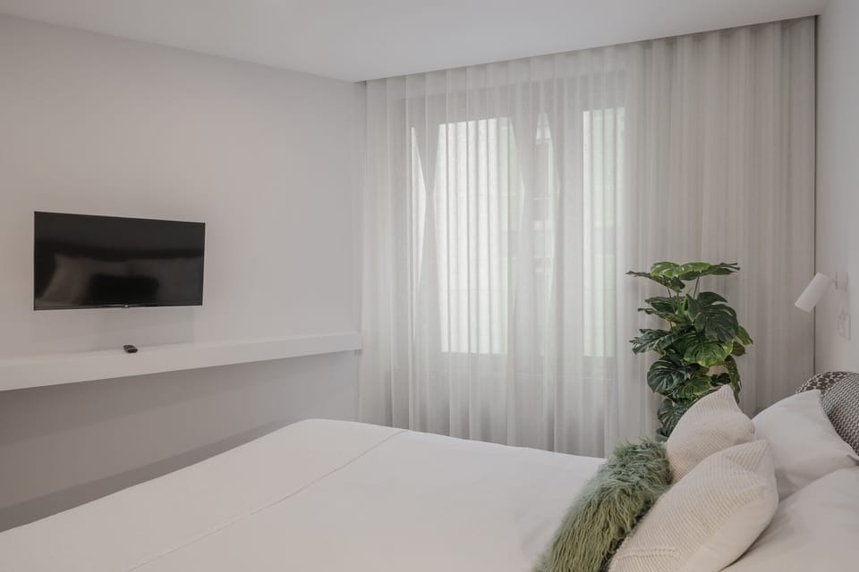 Bedroom with a double bed and a TV