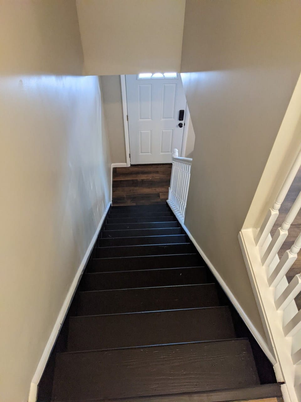 Stairs going down from hallway to living room