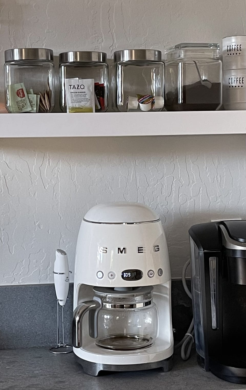 Coffee bar with Keurig machine as well as SMEG coffee maker.